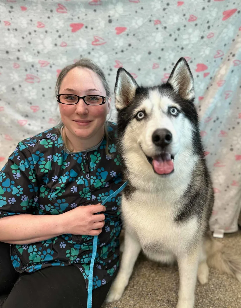 Lindsay, groomer at The Pet Spot, with a husky